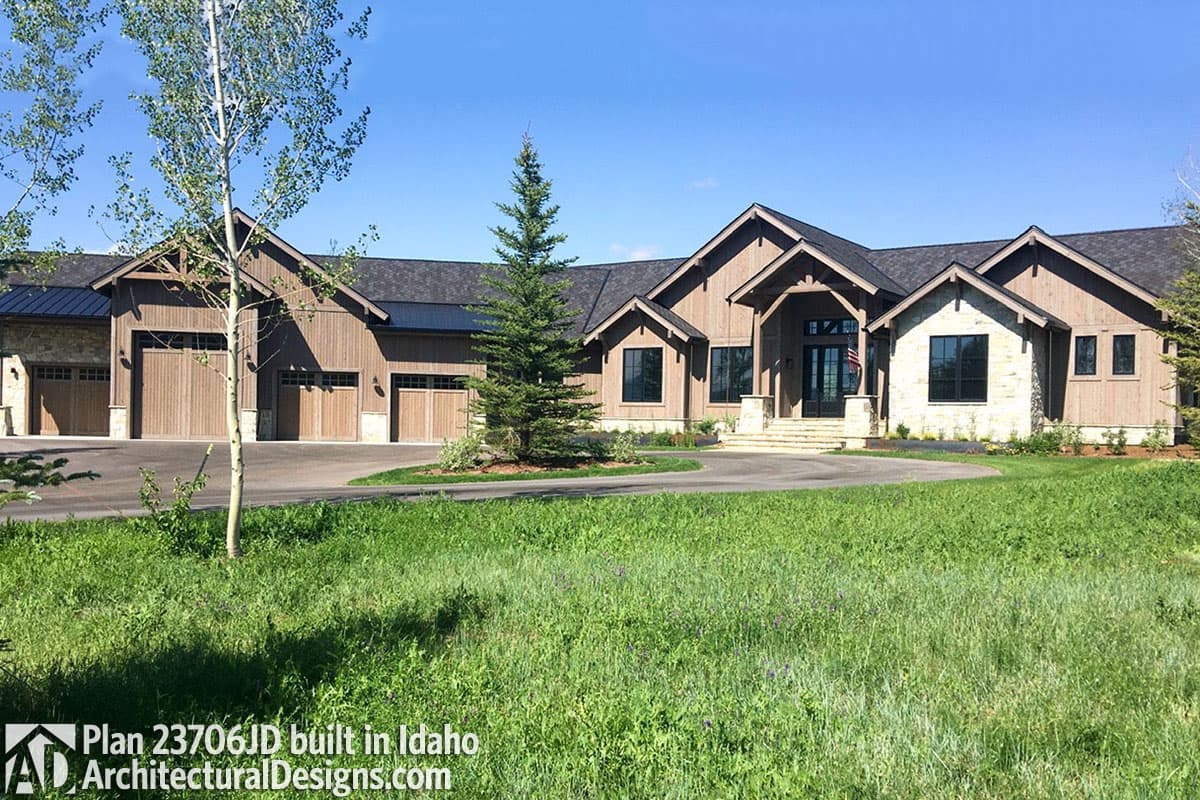 House plan exterior: Contemporary style with multiple gables, wood siding, stone accents, and a five-car garage.