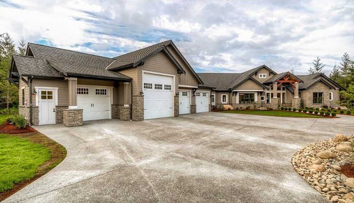 Modern house plan exterior with a large three-car garage, stone accents, gables, and a prominent covered entry.