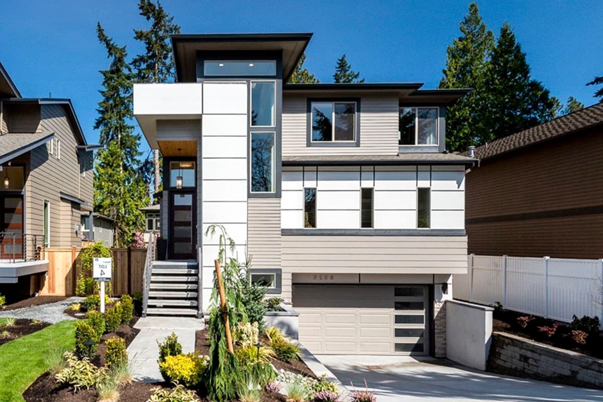 Modern house plan exterior with cantilevered sections, large windows, front-entry garage, and mixed siding.