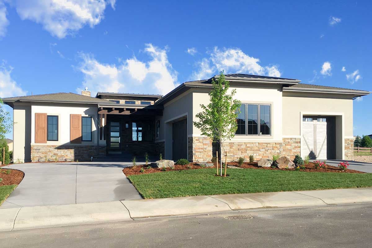 Modern house plan exterior with stone accents, a covered entry with wood beams, and a two-car garage.