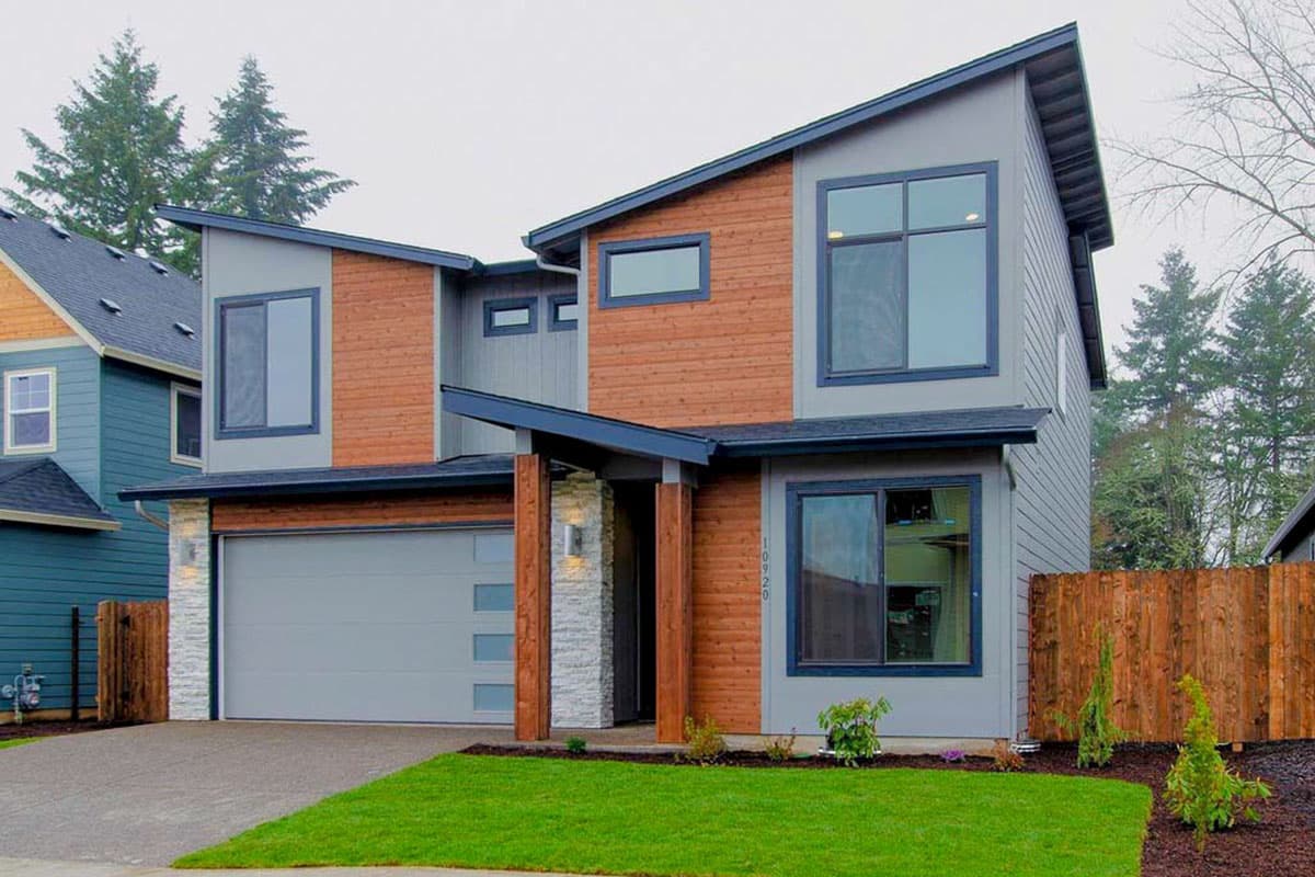 Modern two-story house plan exterior with intersecting gables, wood siding, stone accents, and attached garage.