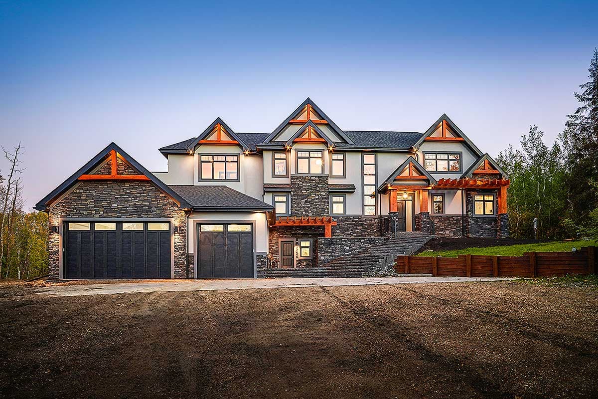 House plan exterior. Two-story, Craftsman-style home with stone and stucco exterior, gabled rooflines, and a pergola-covered front entry.