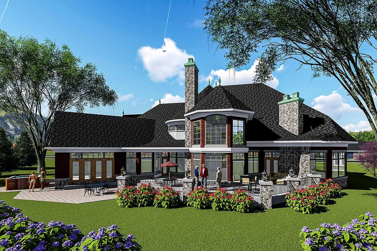 House plan exterior showing a multi-story dwelling with a prominent stone chimney, multi-pane bay window, and expansive patio with hot tub.