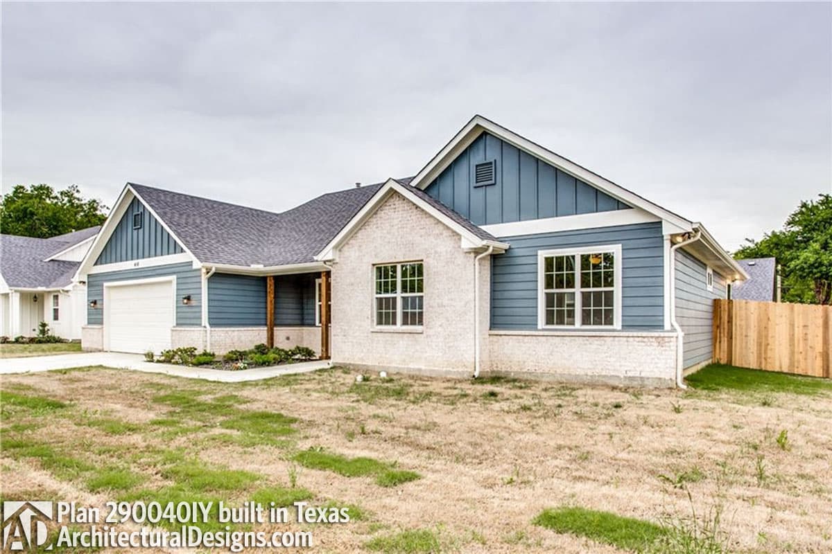 Modern Farmhouse style house plan exterior: one-story, blue siding, white brick, covered front porch, and attached garage.