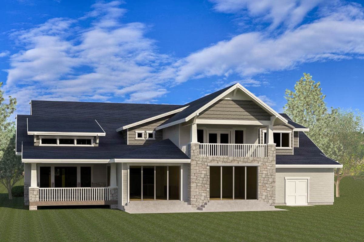 House plan exterior with stone accents, gables, dormers, a covered porch, and a second-story balcony.