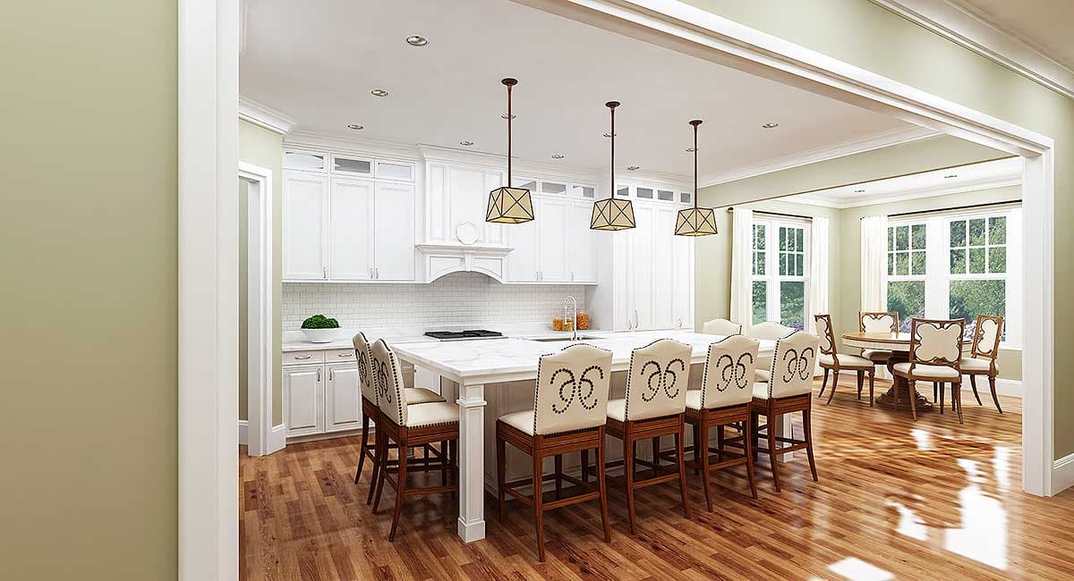 Open-concept kitchen with large island, white cabinetry, subway tile backsplash, and adjoining dining area with bay windows.