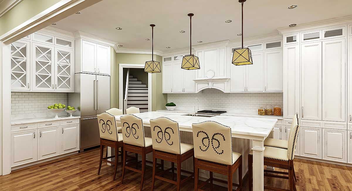 Kitchen with white cabinetry, marble island, subway tile backsplash, stainless steel refrigerator, and view of staircase.