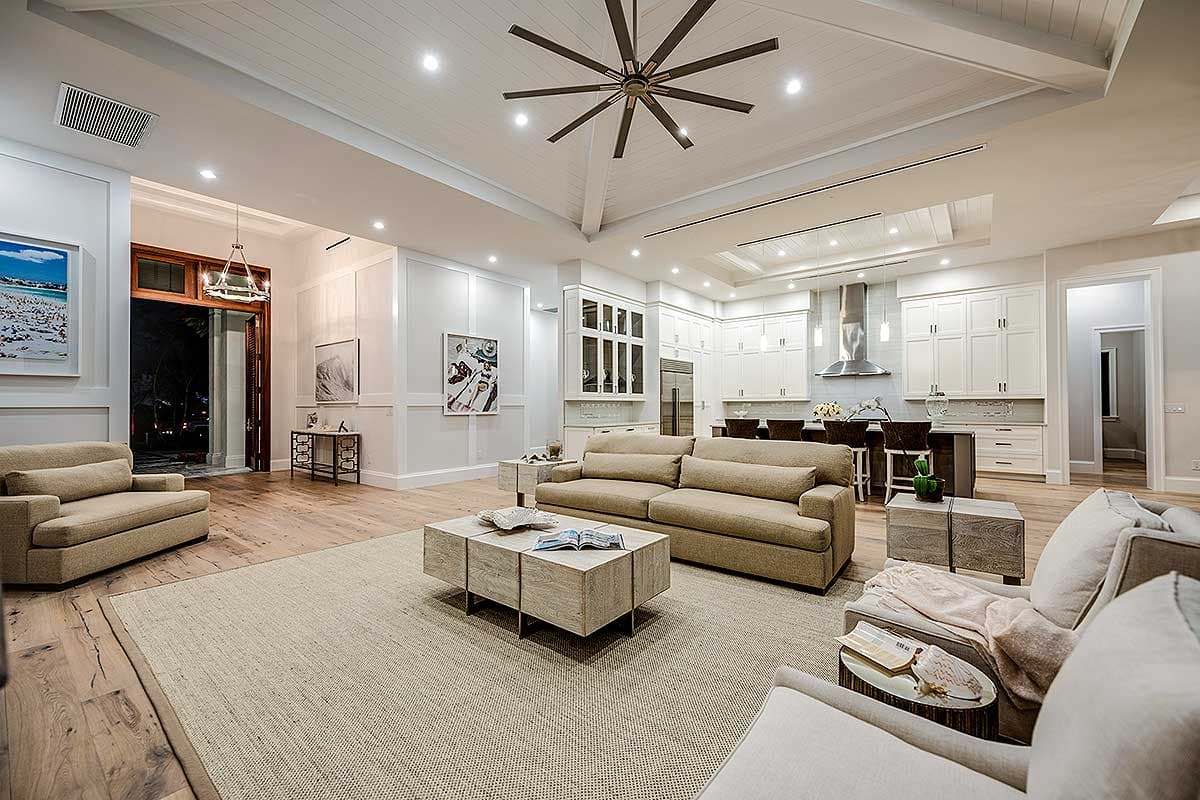 Open concept living area with beamed ceiling, recessed lighting, kitchen island, and a large living room.