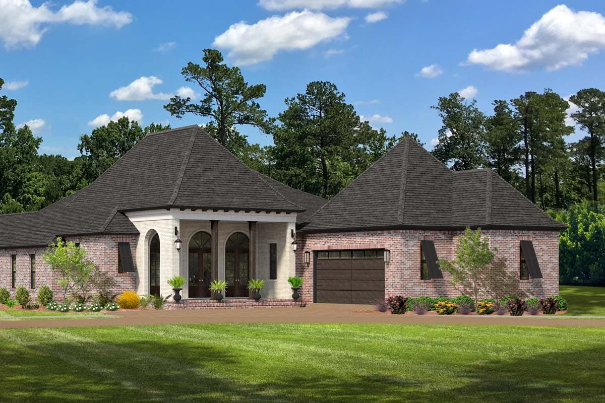 House plan exterior. Two-story French style home with brick and stucco facade, arched entryway, a hipped roof, and attached garage.