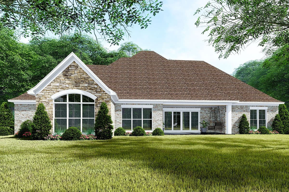 House plan exterior rendering of a one-story home with stone accents, a large arched window, and a covered porch with a swing.
