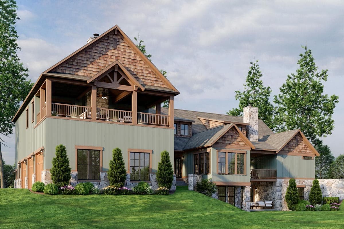 House plan exterior featuring wood shake gables, stone accents, multiple levels, covered deck, and garage doors.