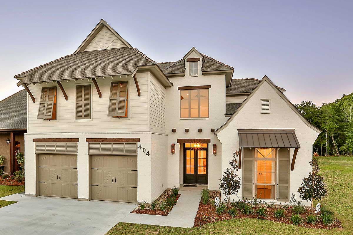 House plan exterior featuring a two-story design with a gable roof, dormers, and a two-car garage. Shutters and a covered entry are visible.