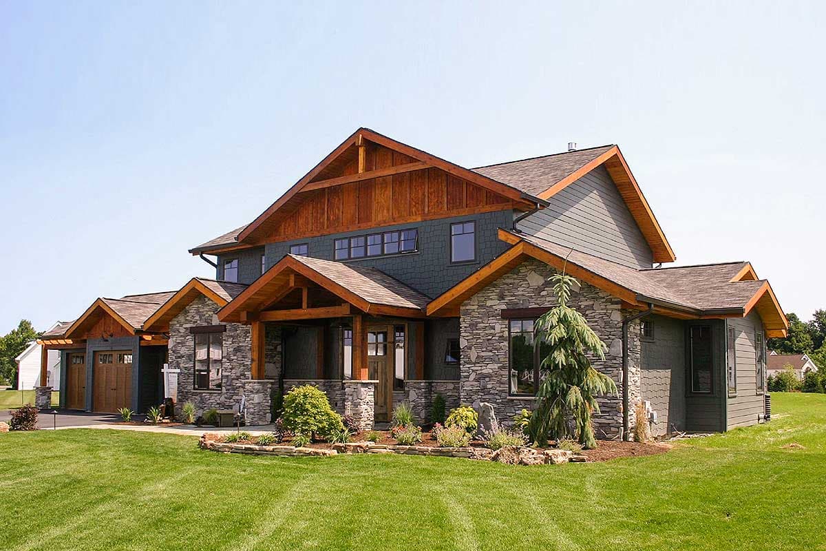 House plan exterior: two-story Modern Farmhouse with stone facade, covered porch, and attached three-car garage.