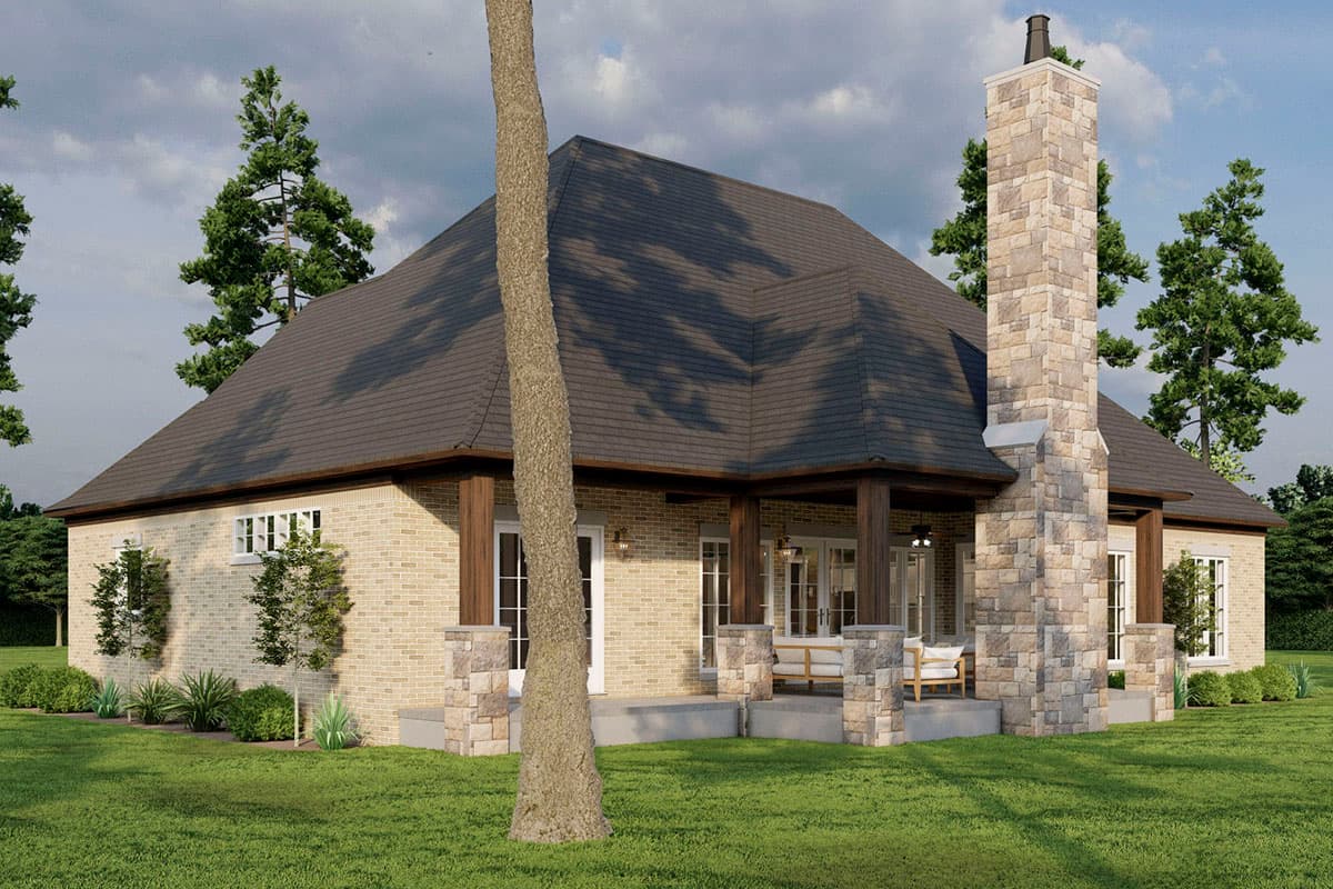 House plan exterior rendering with brick facade, prominent stone chimney, and covered porch with wood columns.