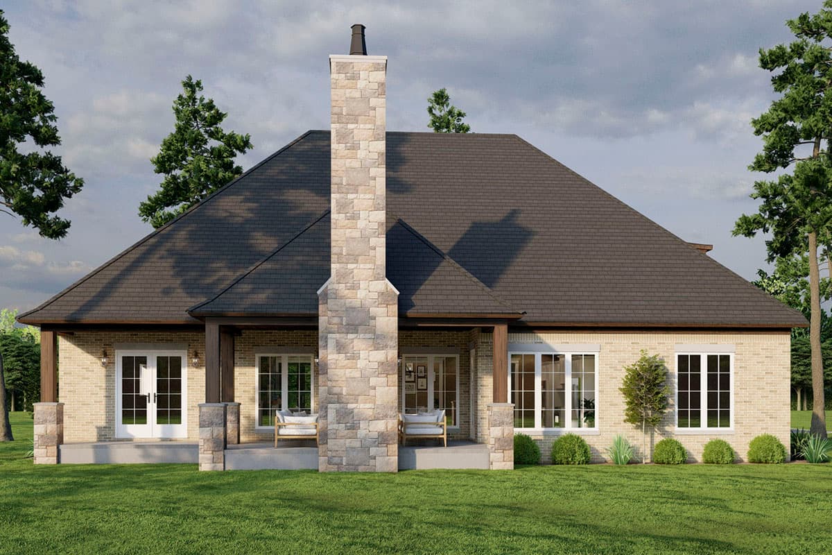 House plan exterior with neutral brick facade, prominent stone chimney, covered porches, and large windows. Single story.