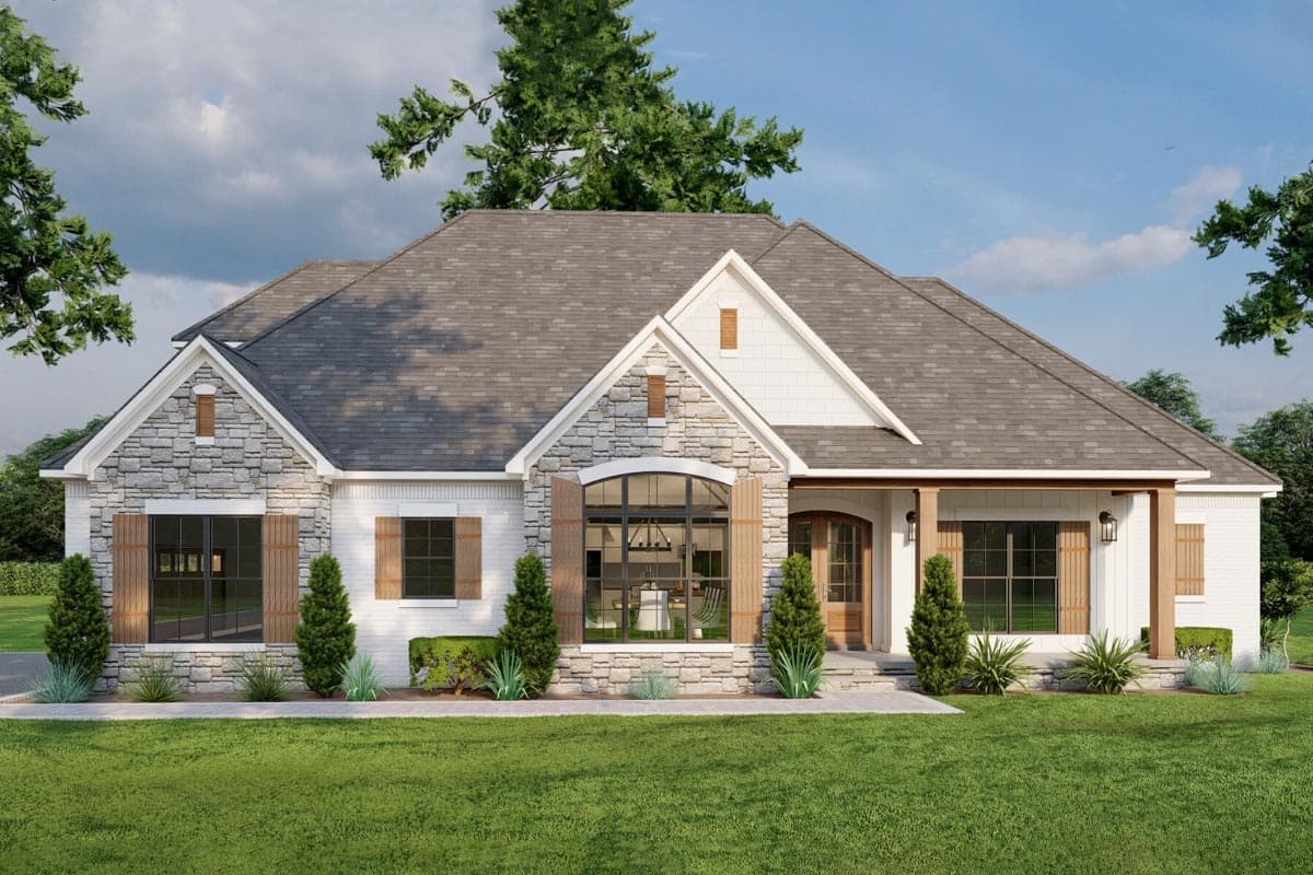 House plan exterior. Ranch style with stone accents and gable roof. Features include an arched window, covered porch, and wood shutters.