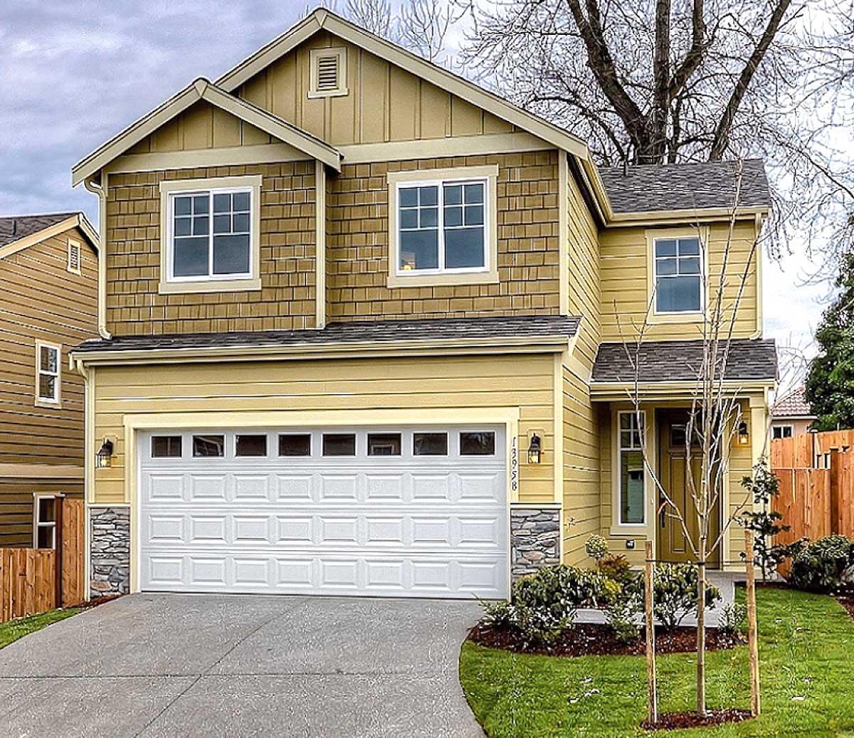 Two-story house plan exterior featuring a Craftsman style, gable roof, shingle siding on the upper story, and an attached garage with stone accents.