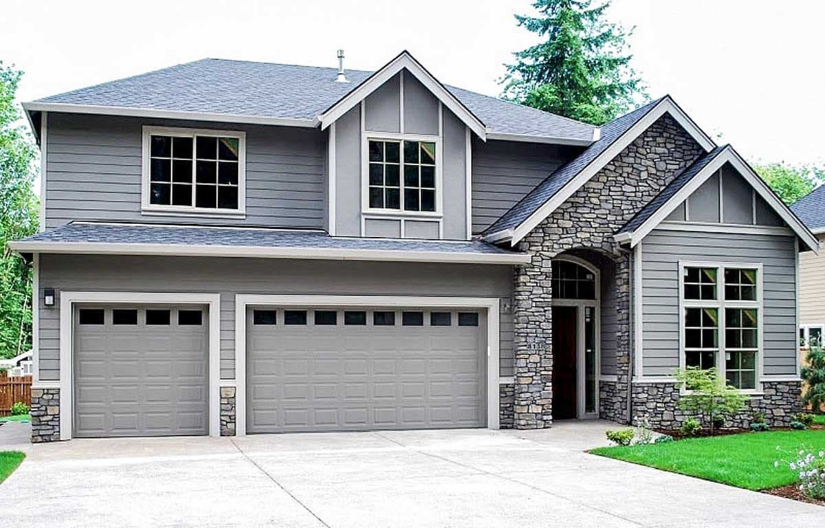 House plan exterior with two stories, Craftsman style. Features include stone accents, gabled rooflines, and a two-car garage.