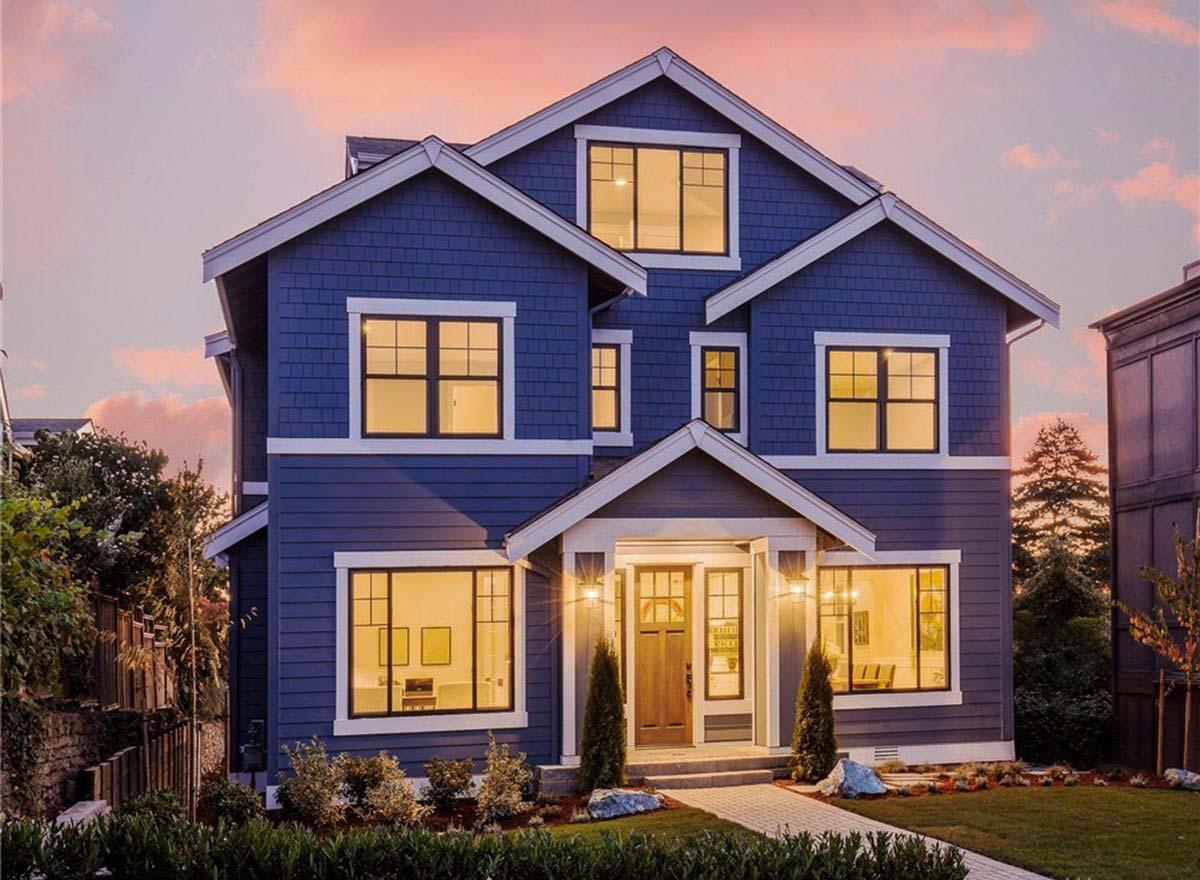 House plan exterior featuring a two-story Craftsman style home with multiple gables, dormers, and a covered front entry. Clapboard siding.
