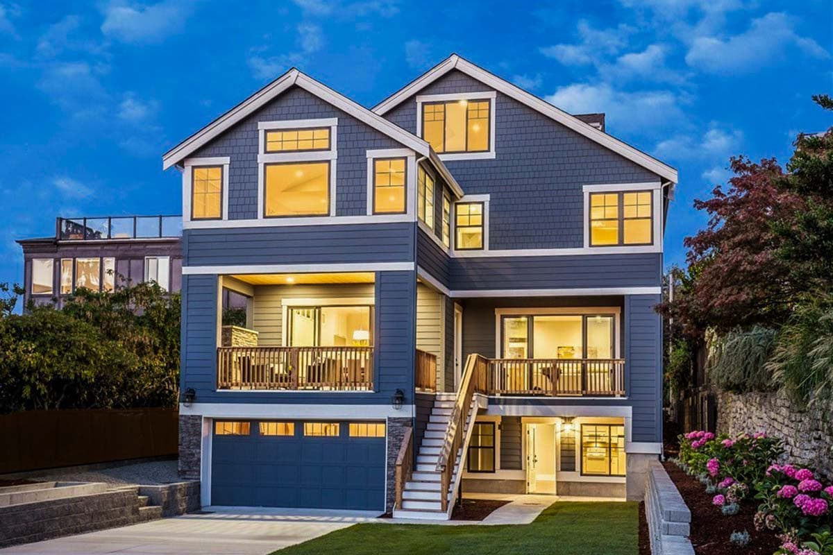 Modern house plan exterior with multiple gables, covered balconies, and a multi-level facade with a two-car garage.