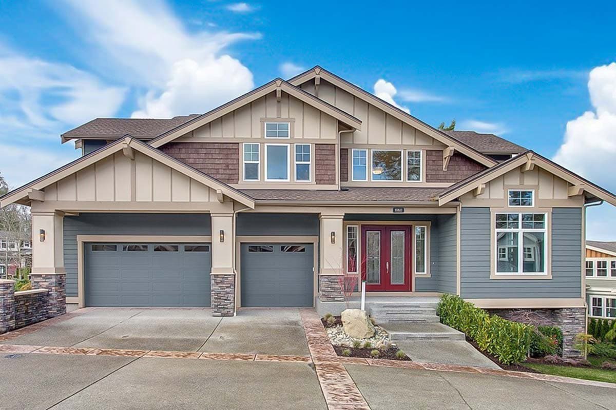House plan exterior. Craftsman style, two-story home with gables, a covered entry, and a three-car garage.