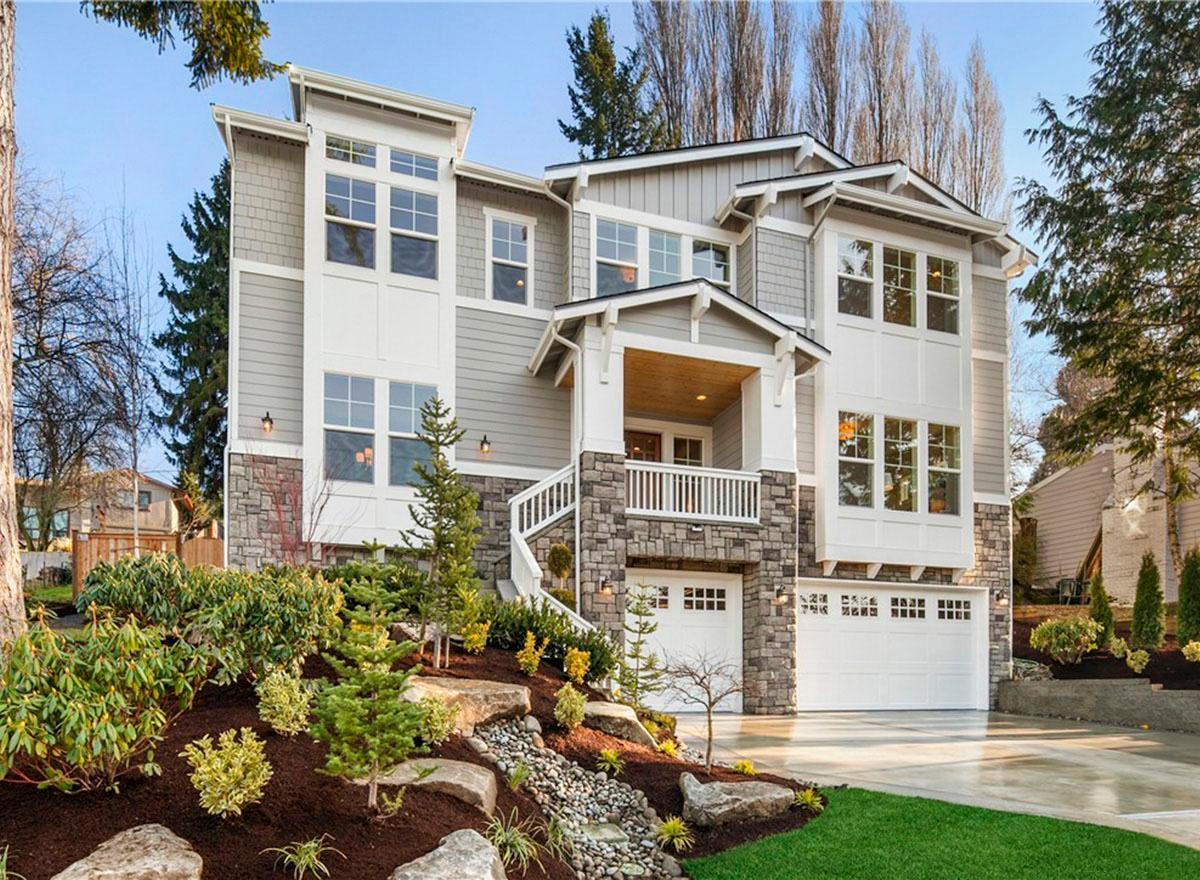 House plan exterior: Modern style, three stories, stone foundation, covered entry porch with balcony, and three garage bays.