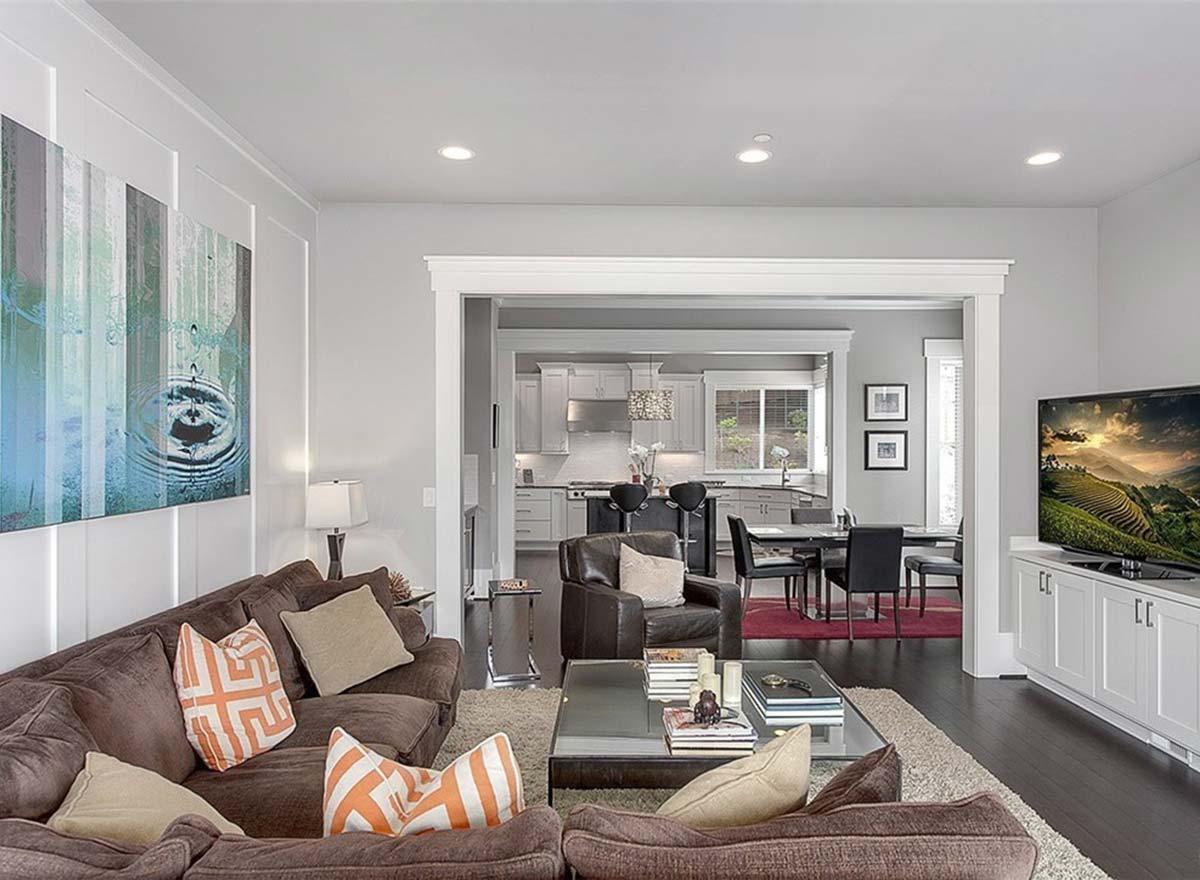 Living room with a sectional sofa and view into a kitchen with island and dining area.