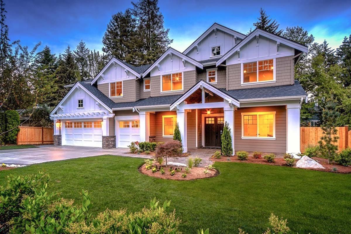 Craftsman house plan exterior, two stories, dual garage doors, gables, dormers, and covered entry porch.