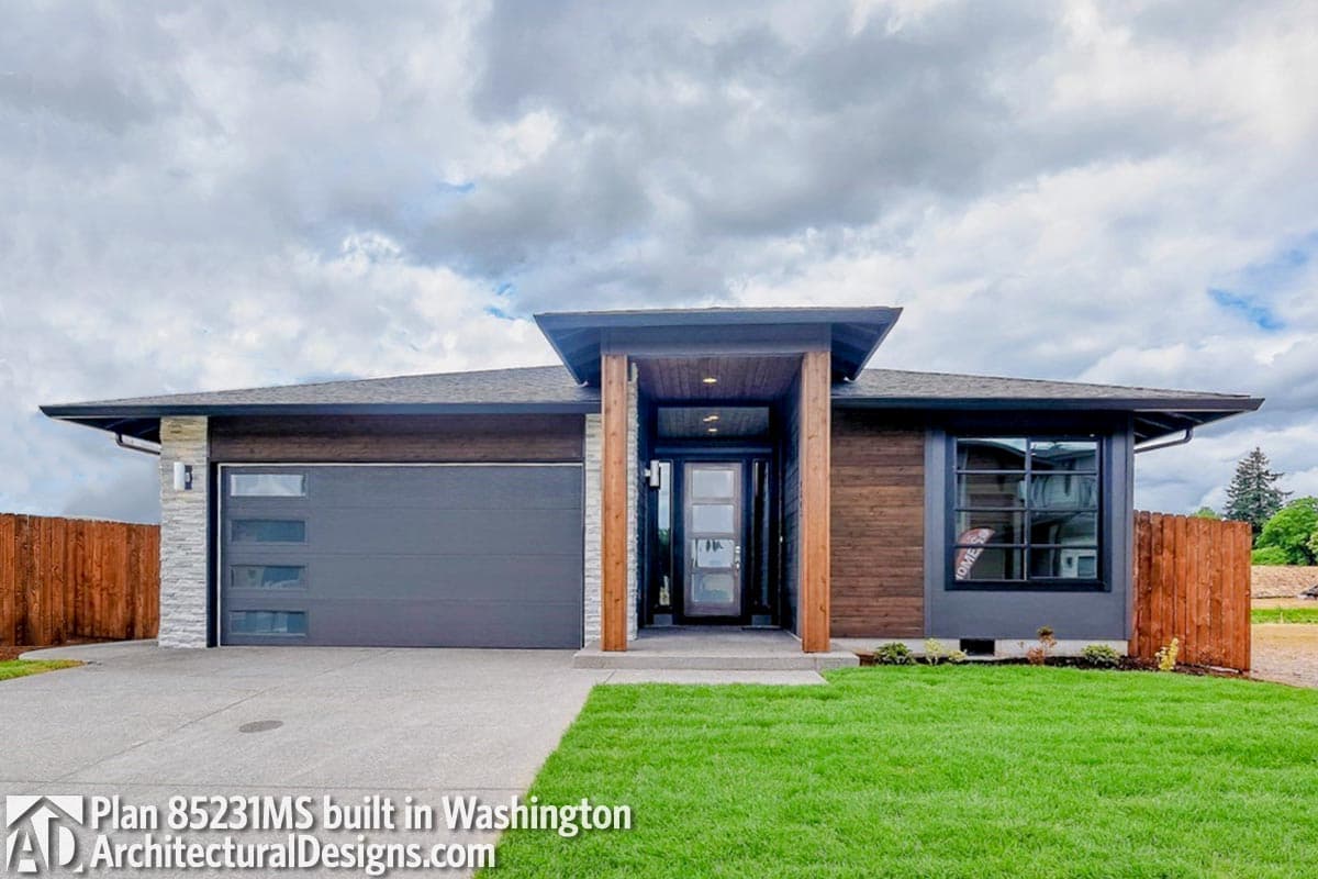 House plan exterior with modern style, one story, a covered entry, flat roof, and an attached garage.