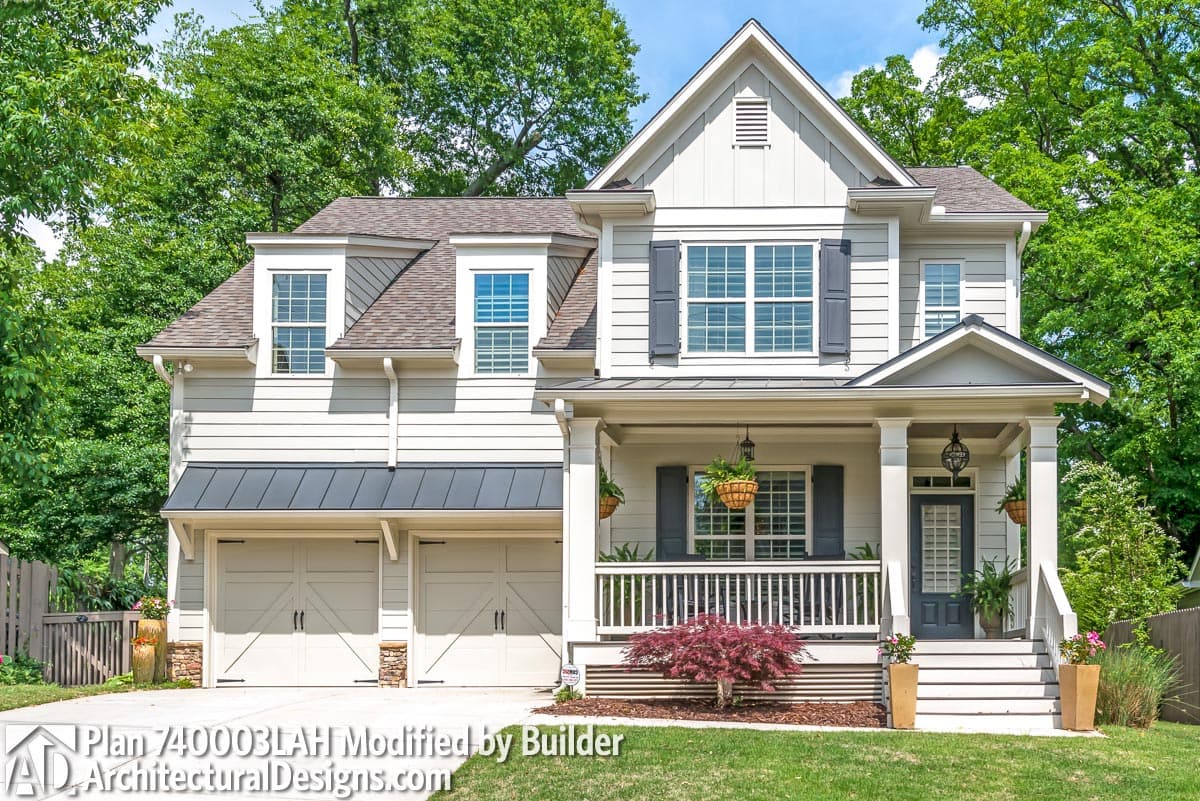 Two-story Modern Farmhouse plan exterior with a wrap-around porch, dual garage doors, and dormer windows.