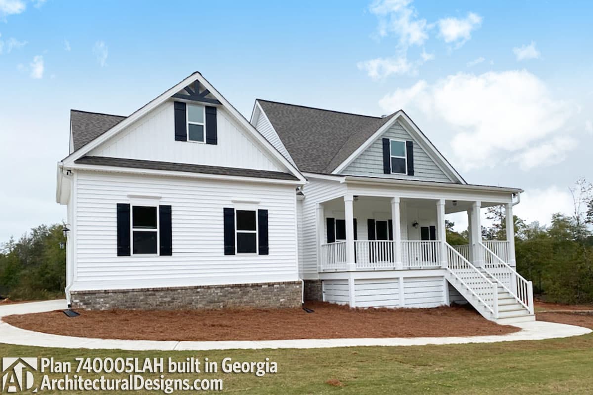 House plan exterior, two stories, white siding, gabled dormers, white porch with white railing and steps.