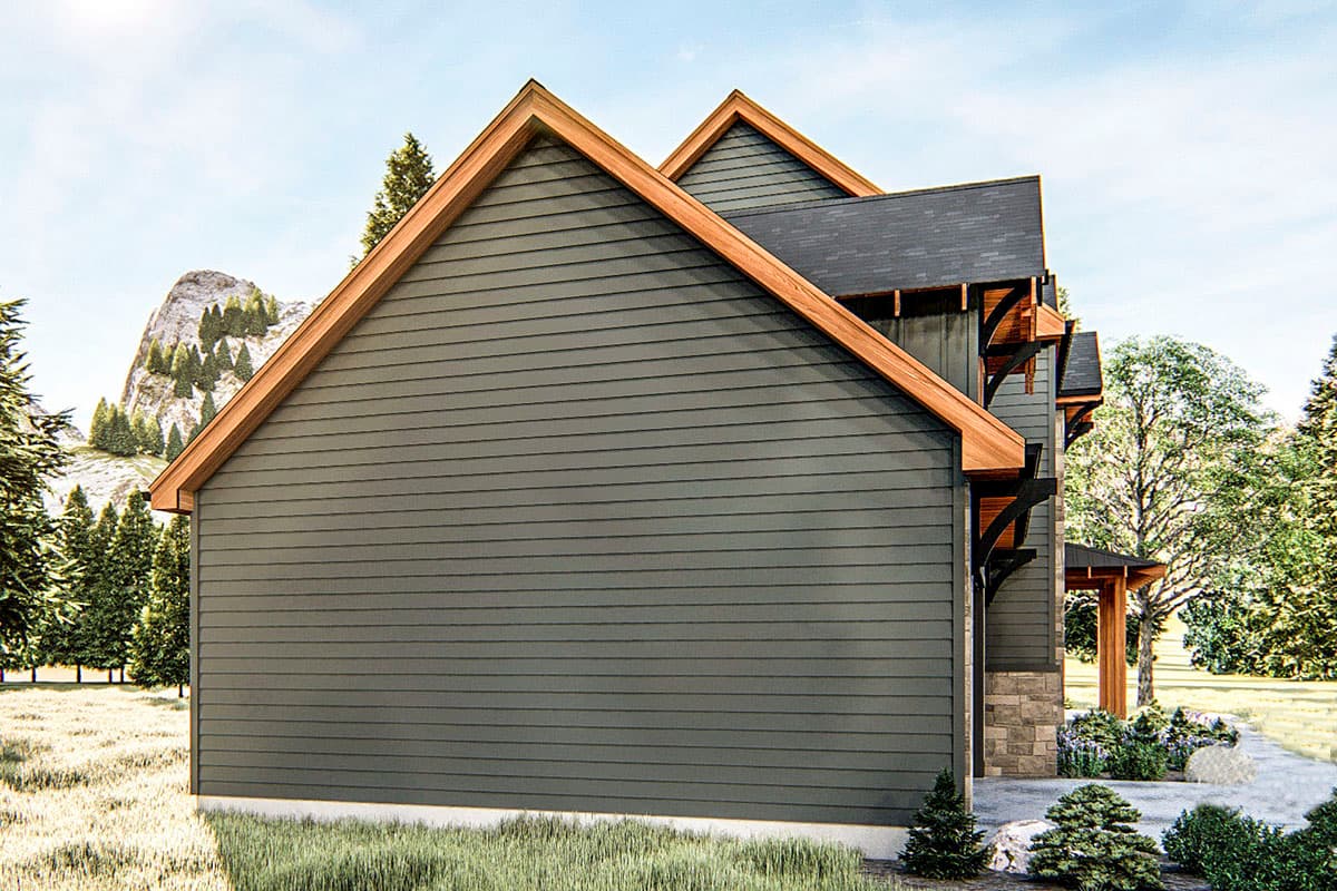 House plan exterior with dark gray siding, prominent gables with wood trim, and decorative rafter tails.