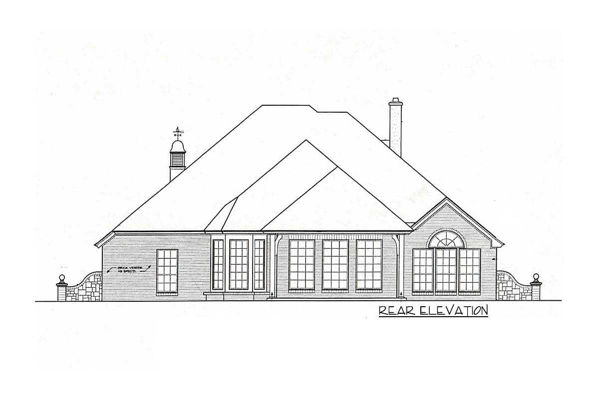 Rear elevation drawing of a house plan with multiple gables, a prominent roofline, arched windows, and brick veneer base.