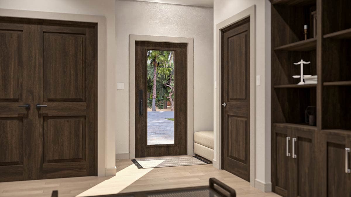 Interior view of a home entryway with wood doors, built-in shelving, and a glass-paneled exterior door.