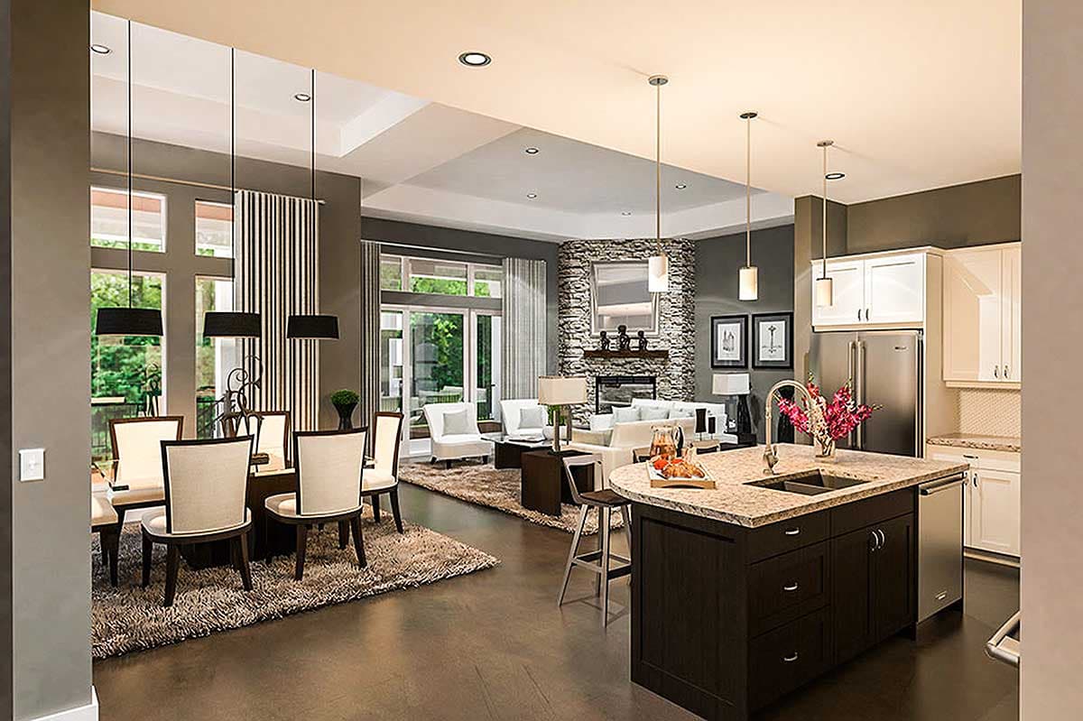 Open concept living, dining, and kitchen area with stone fireplace, large windows, and island with sink.
