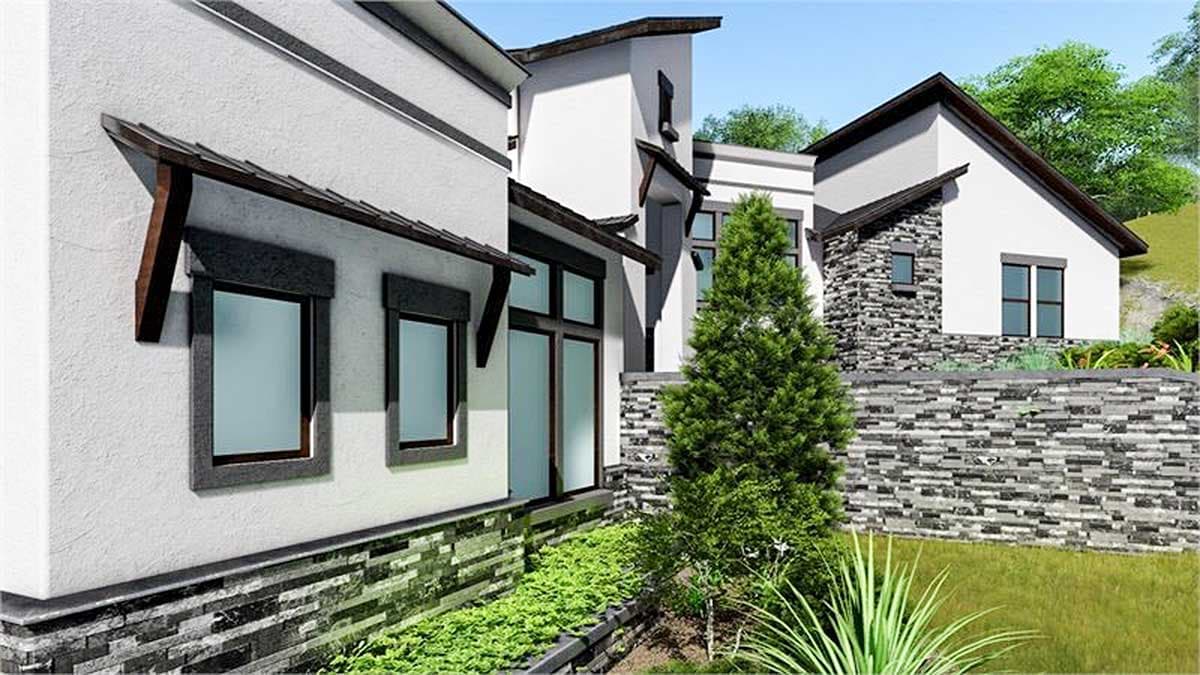 House plan exterior with modern design, stucco walls, stone accents, pitched roofs, and dark-trimmed windows.