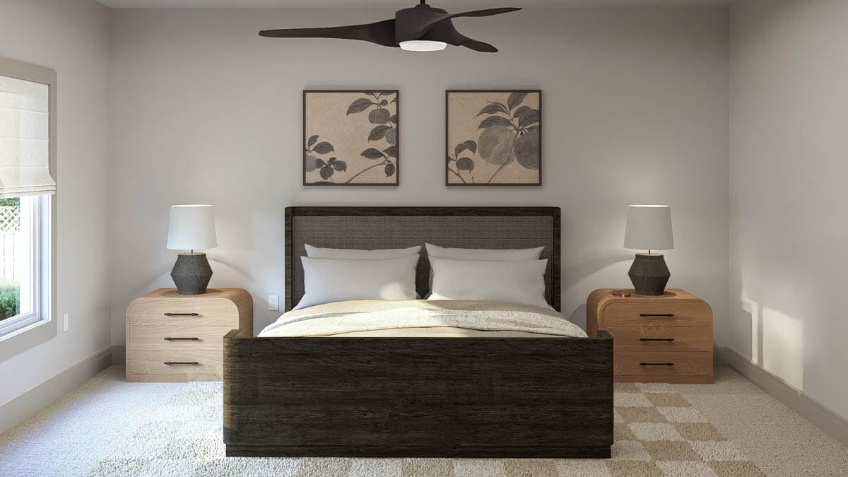 Bedroom with upholstered headboard, wood nightstands with lamps, and ceiling fan. Artwork above bed.