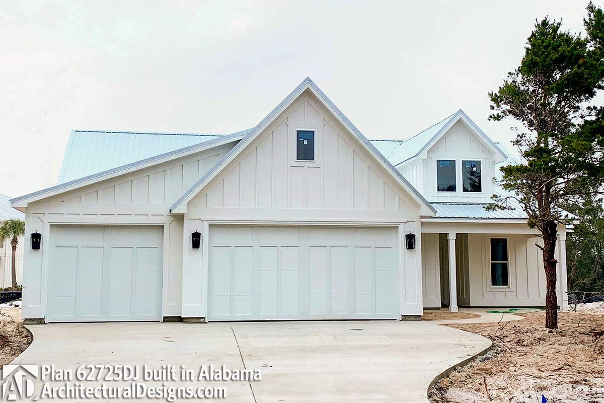 House plan exterior: Modern Farmhouse style, two stories, three-car garage, metal roof, prominent gables, and covered porch.