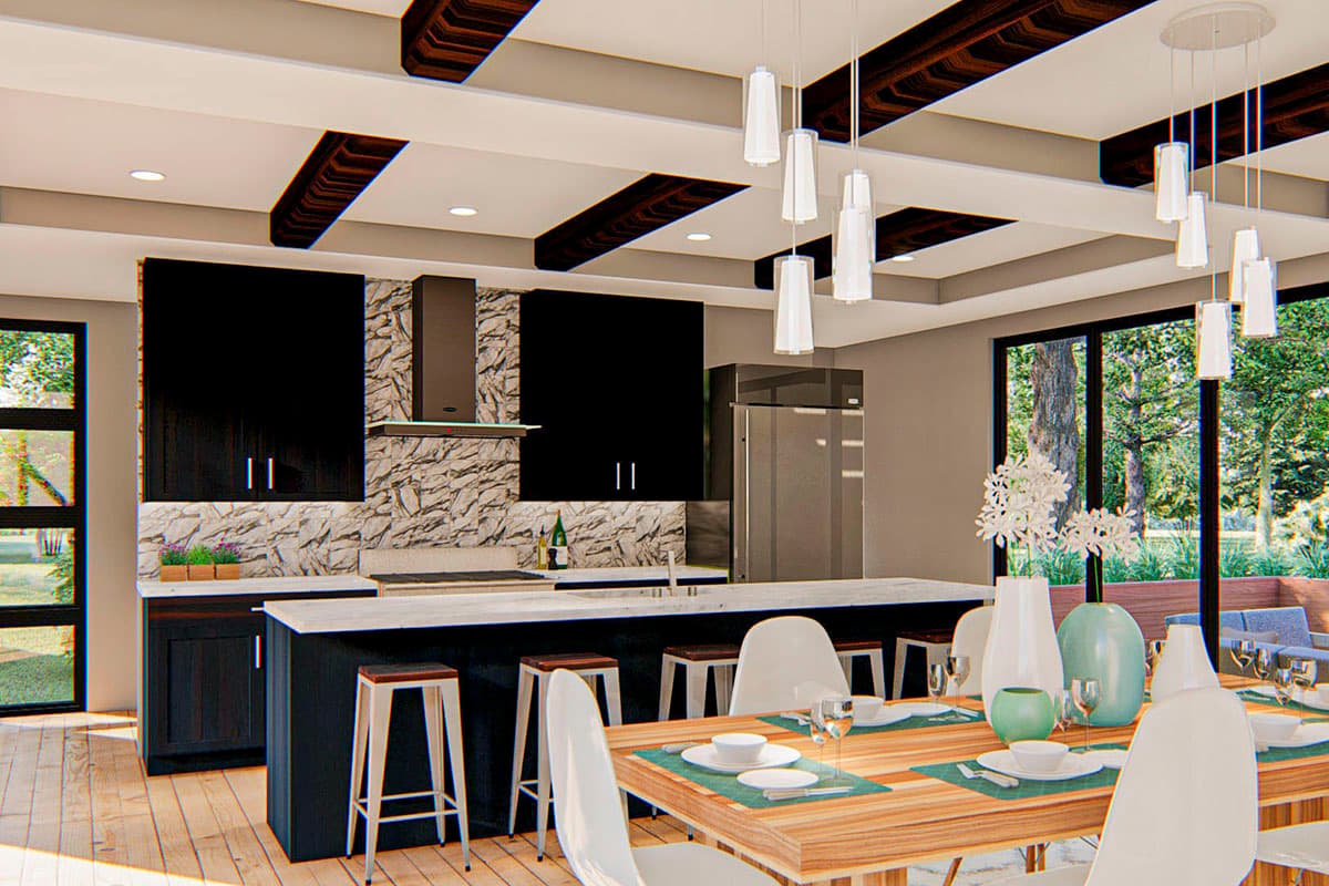 Modern kitchen with black cabinetry, stone backsplash, large island, and open dining area with wood ceiling beams.