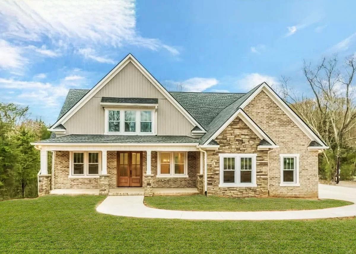 House plan exterior. Two-story home with Craftsman style. Features include a front porch with columns, gables, and stone accents.