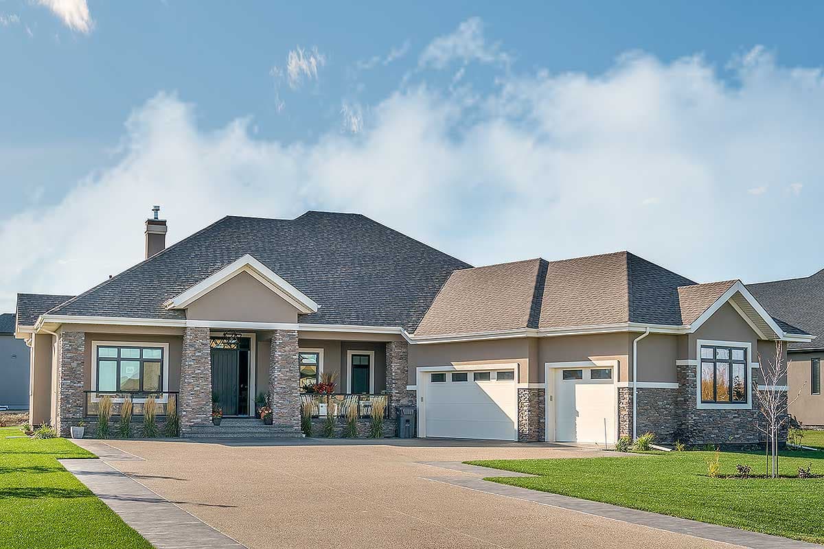 House plan exterior. Single-story home with a gabled roof, stone accents, and a front-entry porch. Attached garage has two bays.