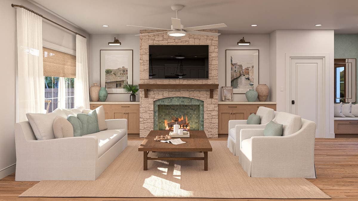 Great room with stone fireplace, entertainment center, two sofas, and a wood coffee table.