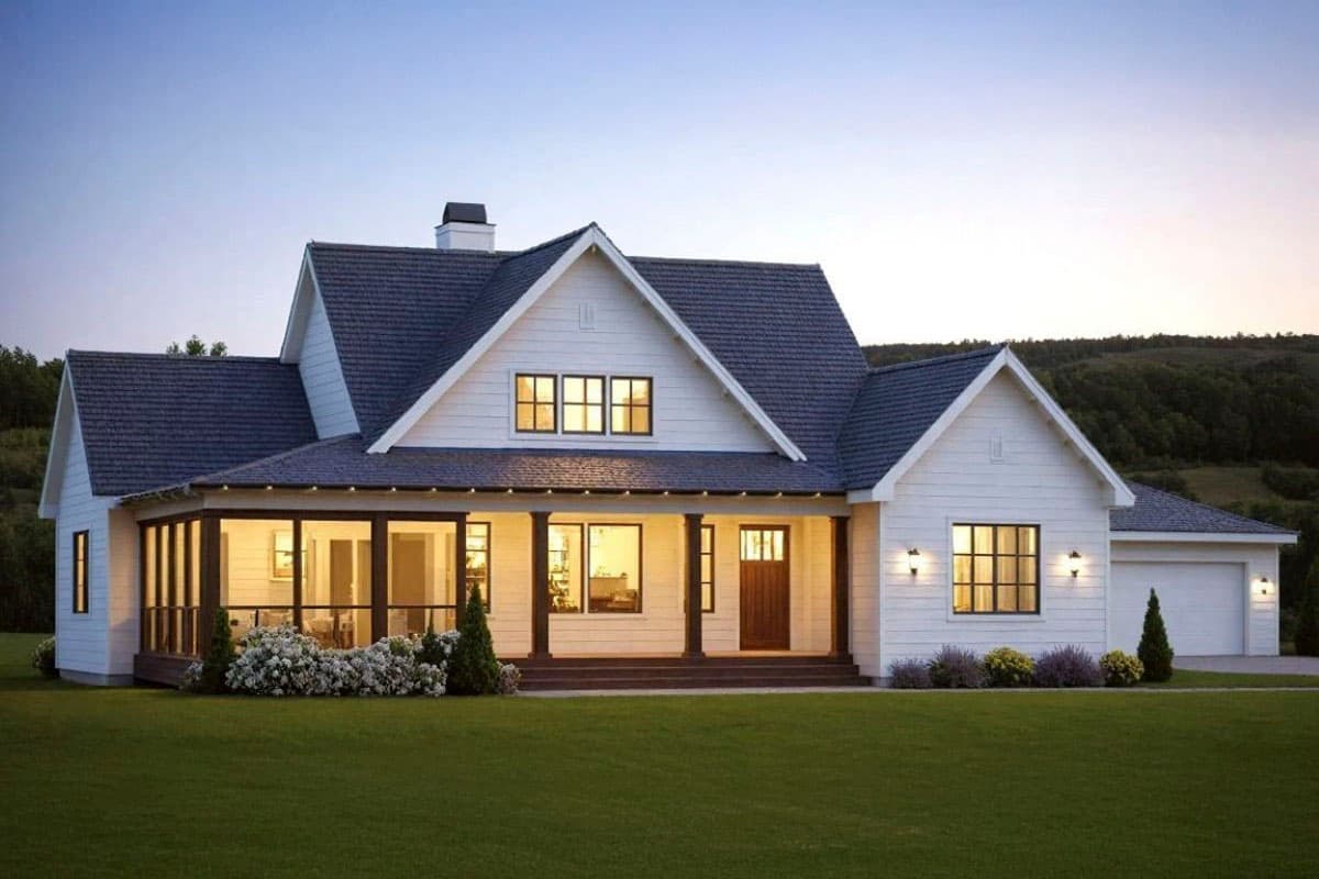 Modern Farmhouse house plan exterior with a wraparound porch, gables, dormers, and a two-car garage.