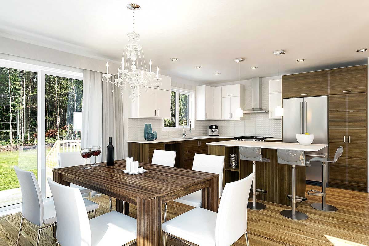 Open concept kitchen and dining area with white cabinets, wood island with bar stools, and large windows.