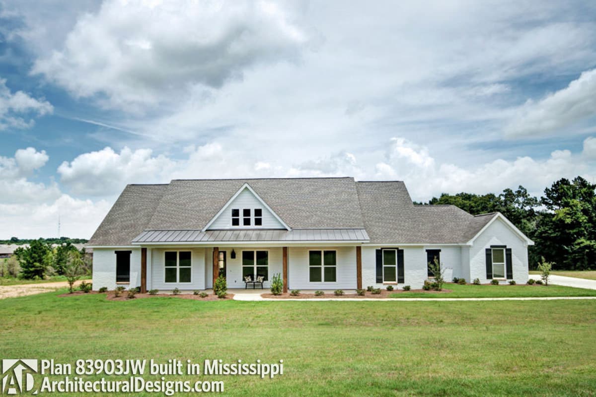 Modern Farmhouse house plan exterior with a covered porch, gabled dormer, and metal roof accents.