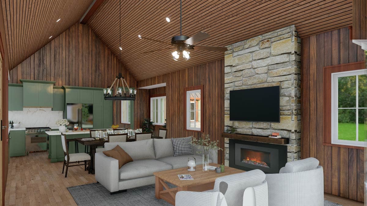 Open-concept living space with vaulted wood ceiling, stone fireplace, kitchen with green cabinets, and dining area.