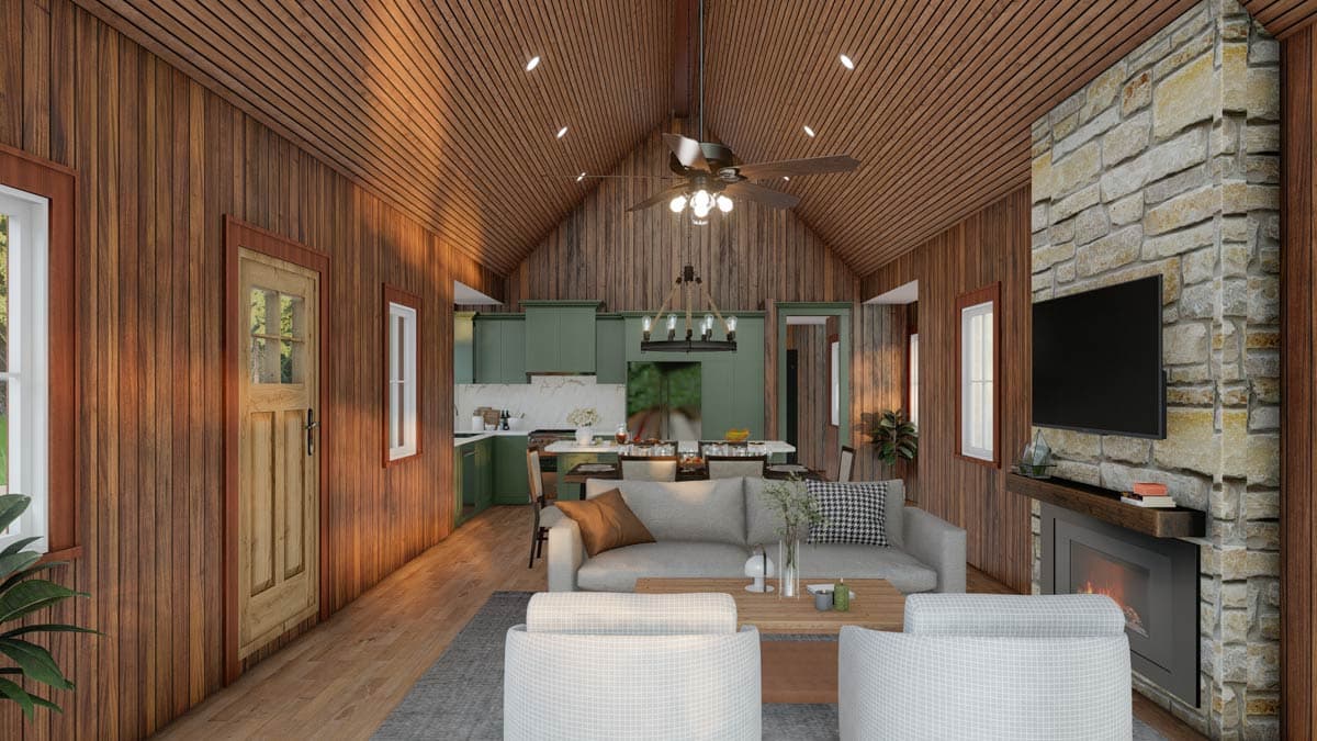 Living room and kitchen with vaulted wood ceiling, stone fireplace, green cabinetry, and wood plank walls.