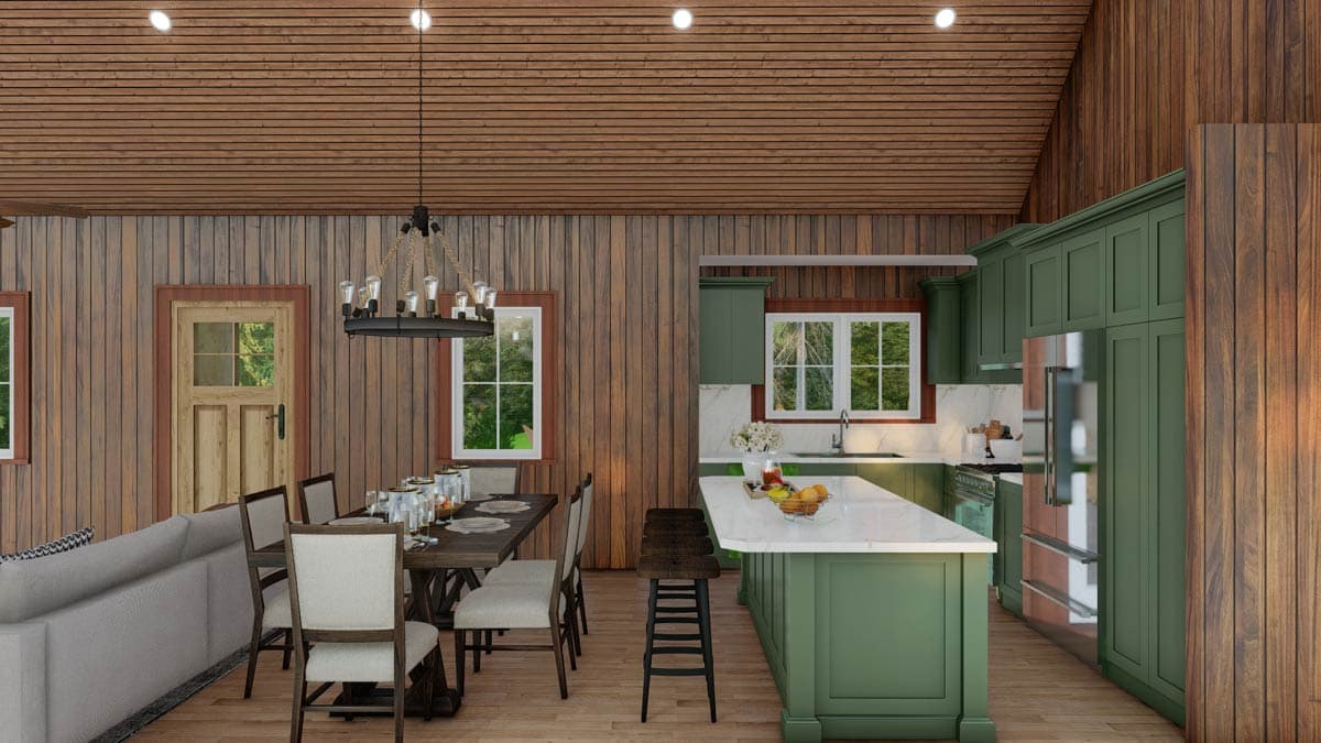 Open concept living and kitchen area with wood paneling, a large dining table, island with seating, and green cabinetry.