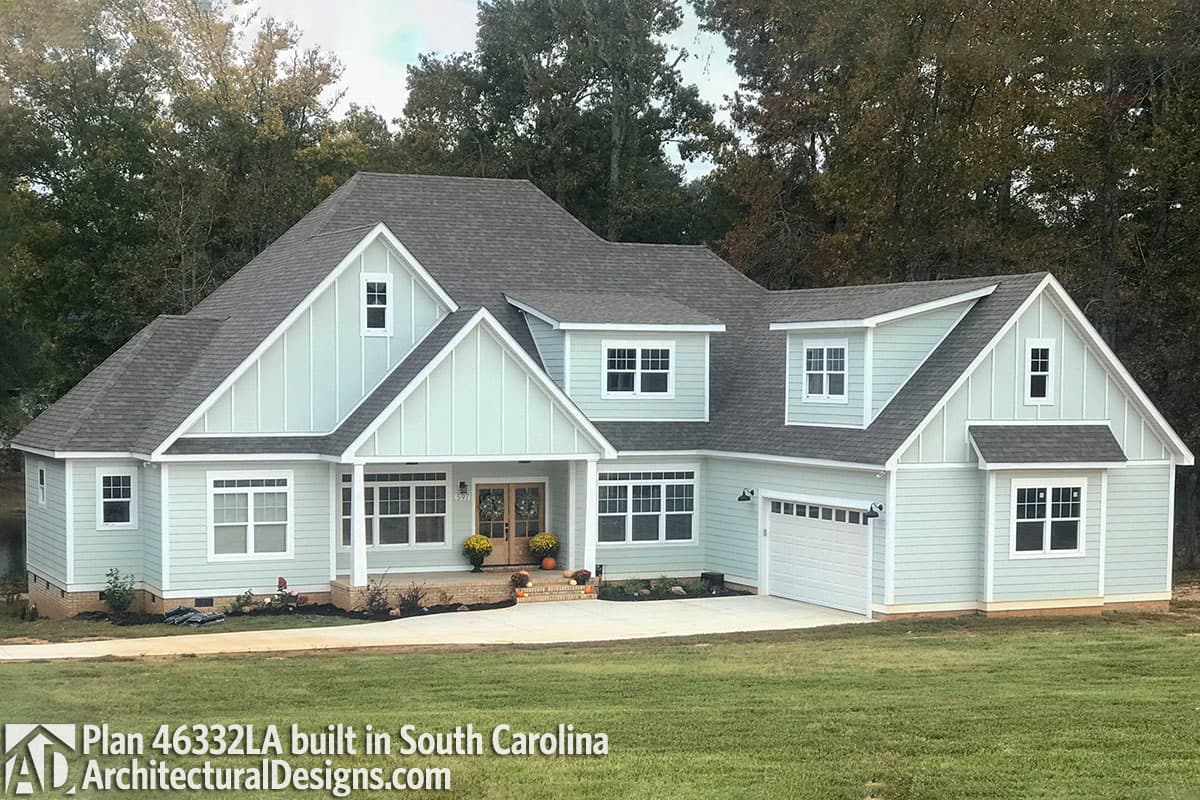 Modern Farmhouse house plan exterior with a covered front porch, board and batten siding, dormers, and a two-car garage.