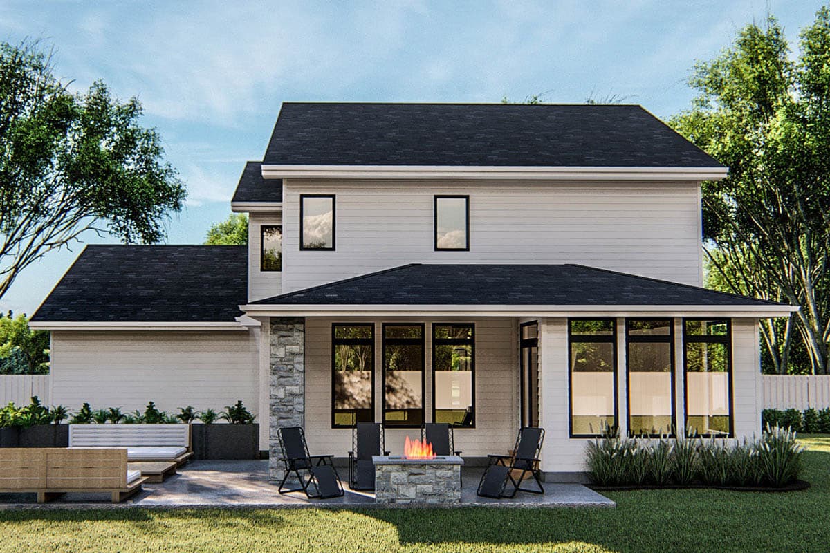 Two-story Modern Farmhouse house plan exterior with a gabled roof, stone accents, and a covered patio with a fire pit.
